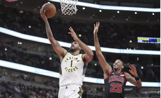 Indiana Pacers' Obi Toppin scores past Chicago Bulls' Dalen Terry during the second half of an NBA basketball game Friday, Dec. 6, 2024, in Chicago. (AP Photo/Charles Rex Arbogast)