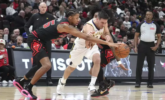 Indiana Pacers' T.J. McConnell drives between the pressure of Chicago Bulls' Dalen Terry, left, and Coby White during the second half of an NBA basketball game Friday, Dec. 6, 2024, in Chicago. (AP Photo/Charles Rex Arbogast)