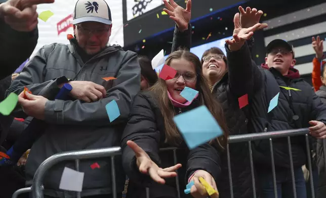 People in the crowd catch confetti ahead of New Year's Eve in Times Square, Sunday, Dec. 29, 2024, in New York. (AP Photo/Heather Khalifa)