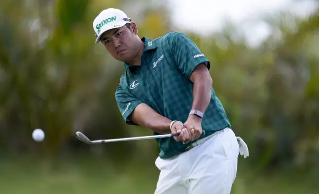 Hideki Matsuyama, of Japan, chips onto the 14th green during the third round of The Sentry golf event, Saturday, Jan. 4, 2025, at Kapalua Plantation Course in Kapalua, Hawaii. (AP Photo/Matt York)