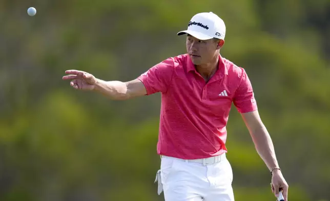 Collin Morikawa tosses his ball on the 17th green during the third round of The Sentry golf event, Saturday, Jan. 4, 2025, at Kapalua Plantation Course in Kapalua, Hawaii. (AP Photo/Matt York)