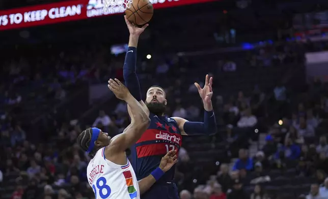 Washington Wizards' Jonas Valanciunas, right, goes up for a shot against Philadelphia 76ers' Guerschon Yabusele during the first half of an NBA basketball game, Wednesday, Jan. 8, 2025, in Philadelphia. (AP Photo/Matt Slocum)