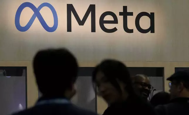 FILE - Attendees visit the Meta booth at the Game Developers Conference in San Francisco on March 22, 2023. (AP Photo/Jeff Chiu, File)