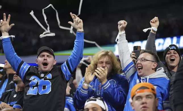 Detroit Lions fans celebrate a touchdown during the second half of an NFL football game between the Detroit Lions and the Minnesota Vikings, Sunday, Jan. 5, 2025, in Detroit. (AP Photo/)