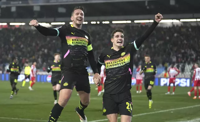 PSV's Luuk de Jong, centre, celebrates with PSV's Guus Til after scoring his side's second goal during the Champions League opening phase soccer match between Red Star and PSV at the Rajko Mitic Stadium in Belgrade, Serbia, Tuesday, Jan. 21, 2025. (AP Photo/Darko Vojinovic)