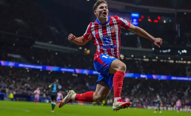 Atletico Madrid's Julian Alvarez celebrates after scoring his side's first goal against Bayer 04 Leverkusen during a Champions League opening phase soccer match at the Riyadh Air Metropolitano stadium in Madrid, Spain, Tuesday, Jan. 21, 2025. (AP Photo/Manu Fernandez)