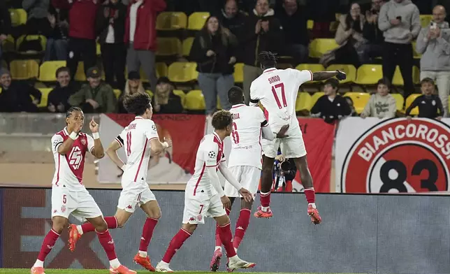 Monaco's Wilfried Singo, right, celebrates after scoring the opening goal of his team during a Champions League opening phase soccer match between Monaco and Aston Villa at the Louis II stadium in Monaco, Tuesday, Jan. 21, 2025. (AP Photo/Laurent Cipriani)