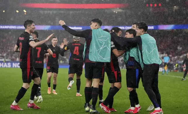 Barcelona celebrate their side's fourth goal during a Champions League opening phase soccer match between SL Benfica and FC Barcelona at the Luz stadium in Lisbon, Tuesday, Jan. 21, 2025. (AP Photo/Armando Franca)