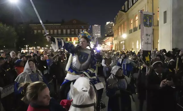 A person dressed as Joan of Arc holds a sword on-top of a horse during the annual Krewe de Jeanne d'Arc parade, kicking off the Mardi Gras season, in New Orleans, Monday, Jan. 6, 2025. (AP Photo/Gerald Herbert)