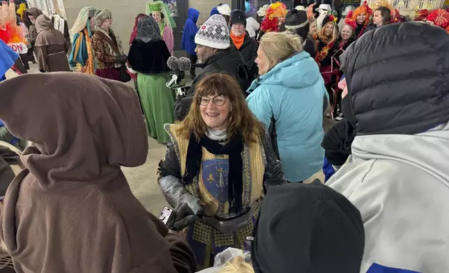 Antoinette de Alteriis, co-captain of the Krewe de Jeanne d'Arc, organizes volunteers before the start of the Joan of Arc parade on Monday, Jan. 6, 2025, in New Orleans. (AP Photo/Jack Brook)