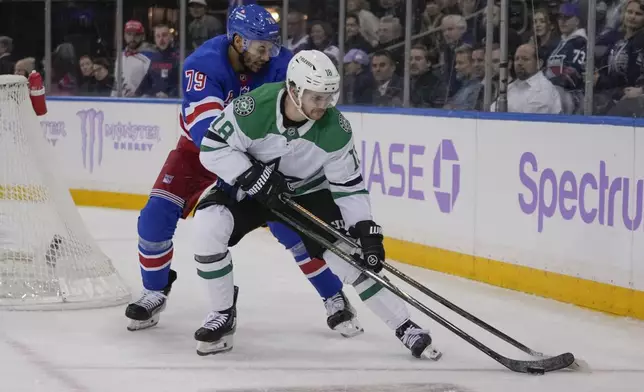 New York Rangers' K'Andre Miller (79) fights for control of the puck with Dallas Stars' Sam Steel (18) during the third period of an NHL hockey game, Tuesday, Jan. 7, 2025, in New York. (AP Photo/Frank Franklin II)