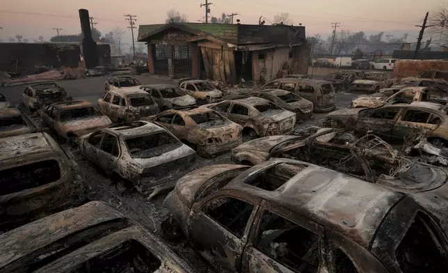 Cars are left charred inside a dealership in the aftermath of the Eaton Fire Friday, Jan. 10, 2025 in Altadena, Calif. (AP Photo/Jae C. Hong)