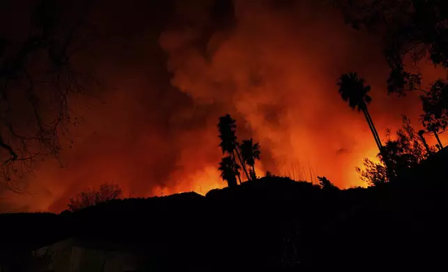 The Palisades Fire burns in Mandeville Canyon on Friday, Jan. 10, 2025, in Los Angeles. (AP Photo/Eric Thayer)