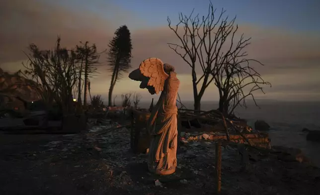 A statue stands amid damage from the Palisades Fire on Friday, Jan. 10, 2025, in Malibu, Calif. (AP Photo/Eric Thayer)