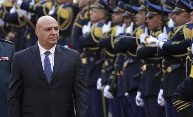 Newly-elected Lebanese President Joseph Aoun reviews the honor guard upon his arrival at the Lebanese Parliament to be sworn in as a new president, in Beirut, Lebanon, Thursday, Jan. 9, 2025. (AP Photo/Hussein Malla)