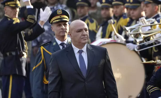 Newly-elected Lebanese President Joseph Aoun reviews the honor guard upon his arrival at the Lebanese Parliament to be sworn in as a new president, in Beirut, Lebanon, Thursday, Jan. 9, 2025. (AP Photo/Hussein Malla)