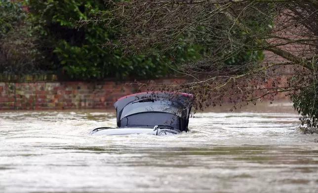 A vehicle is submerged under water near the River Devon, in Bottesford, Leicestershire, England, Monday, Jan. 6, 2025. (Mike Egerton/PA via AP)