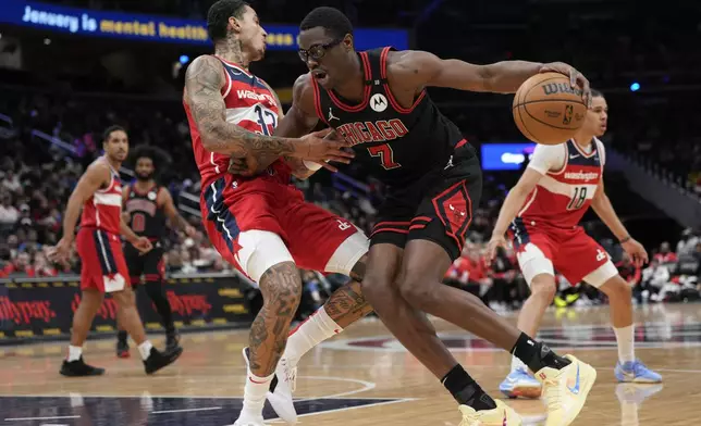 Chicago Bulls forward Jalen Smith (7) dribbles to the hoop against Washington Wizards forward Kyle Kuzma (33) during the first half of an NBA basketball game, Wednesday, Jan. 1, 2025, in Washington. (AP Photo/Jess Rapfogel)