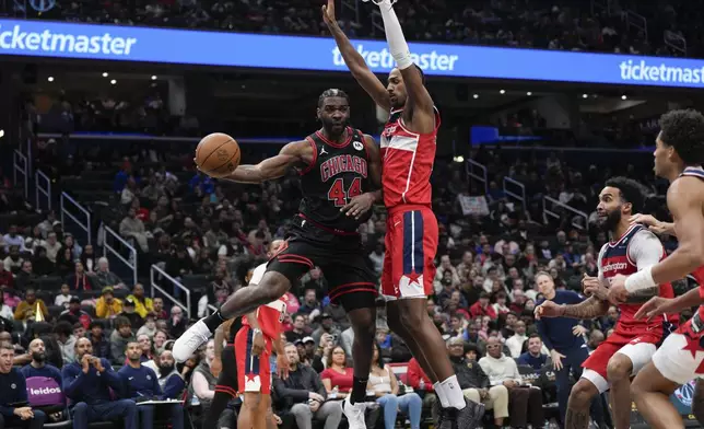 Chicago Bulls forward Patrick Williams (44) passes the ball as Washington Wizards forward Alex Sarr (20) defends during the first half of an NBA basketball game, Wednesday, Jan. 1, 2025, in Washington. (AP Photo/Jess Rapfogel)