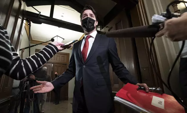 FILE - Prime Minister Justin Trudeau gestures as he speaks with reporters before caucus on Parliament Hill, in Ottawa, on Nov. 24, 2021. (Adrian Wyld/The Canadian Press via AP, File)