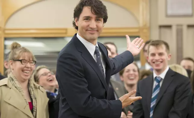 FILE - Liberal Leader Justin Trudeau gestures for media to leave so he can begin his first caucus meeting as leader on April 17, 2013, in Ottawa. (Adrian Wyld/The Canadian Press via AP, File)