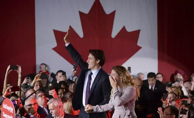 FILE - Liberal leader Justin Trudeau makes his way to the stage with wife Sophie Gregoire at the Liberal party headquarters in Montreal on Oct. 20, 2015. Trudeau, the son of late Prime Minister Pierre Trudeau, became Canada's new prime minister after beating Conservative Stephen Harper. (Sean Kilpatrick/The Canadian Press via AP, File)