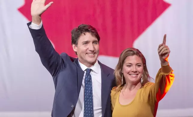 FILE - Liberal leader Justin Trudeau celebrates with his wife, Sophie Gregoire, after winning a minority government at the election night headquarters on Oct. 22, 2019, in Montreal. (Ryan Remiorz/The Canadian Press via AP, File)