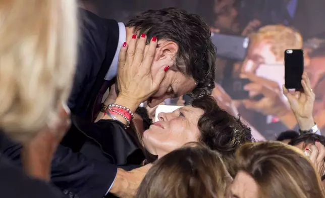 FILE - Liberal leader and Prime Minister Elect Justin Trudeau hugs his mother Margaret Trudeau as he makes his way on stage for his acceptance speech at Liberal party headquarters in Montreal on Oct. 19, 2015, after winning the 42nd Canadian general election. (Justin Tang/The Canadian Press via AP, File)