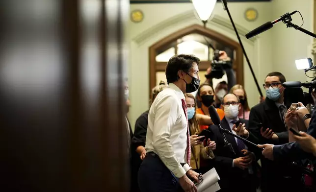 FILE - Prime Minister Justin Trudeau talks to reporters as he arrives at a caucus meeting on Parliament Hill in Ottawa on April 6, 2022. (Sean Kilpatrick/The Canadian Press via AP, File)