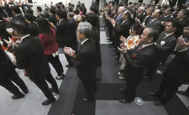 Staff of the Tokyo Stock Exchange and guests make a ceremonial hand-clapping during a ceremony marking the start of this year's trading Monday, Jan. 6, 2025, in Tokyo. (AP Photo/Eugene Hoshiko)