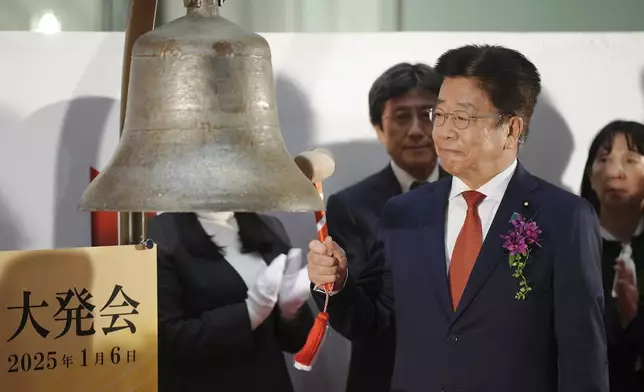 Japan's Finance Minister Katsunobu Kato tolls a bell during a ceremony marking the start of this year's trading Monday, Jan. 6, 2025, in Tokyo. (AP Photo/Eugene Hoshiko)