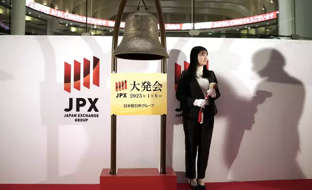 A staff of the Tokyo Stock Exchange prepares to start a ceremony marking the start of this year's trading Monday, Jan. 6, 2025, in Tokyo. (AP Photo/Eugene Hoshiko)