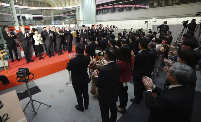 Staff of the Tokyo Stock Exchange and guests make a ceremonial hand-clapping during a ceremony marking the start of this year's trading Monday, Jan. 6, 2025, in Tokyo. (AP Photo/Eugene Hoshiko)