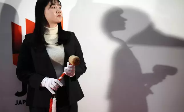 A staff of the Tokyo Stock Exchange prepares to start a ceremony marking the start of this year's trading Monday, Jan. 6, 2025, in Tokyo. (AP Photo/Eugene Hoshiko)