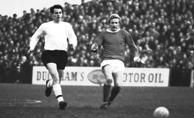 Manchester United's Denis Law, right, and Fulham's Bobby Robson give chase during their an English first division soccer match at Craven Cottage in London, Jan. 15, 1966. (AP Photo/Robert Rider-Rider, File)