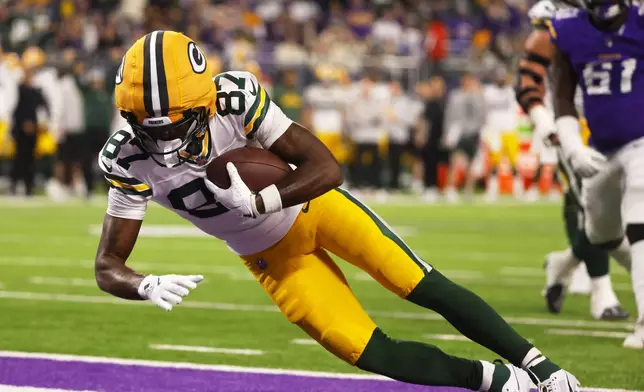 Green Bay Packers' Romeo Doubs catches a pass for a two point conversion during the second half of an NFL football game against the Minnesota Vikings Sunday, Dec. 29, 2024, in Minneapolis. (AP Photo/Bruce Kluckhohn)