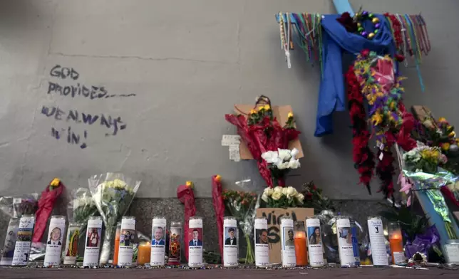 A memorial for the victims of a deadly truck attack on New Year's Day stands on the sidewalk in the French Quarter of New Orleans, Friday, Jan. 3, 2025. (AP Photo/George Walker IV)