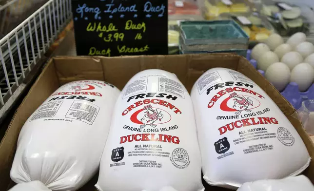 FILE - Whole ducklings, processed and packaged fresh that morning, sit in a cooler for sale at a retail store just over a mile away from their origin at Crescent Duck Farm, in Aquebogue, N.Y., Oct. 29, 2014. (AP Photo/Julie Jacobson, File)