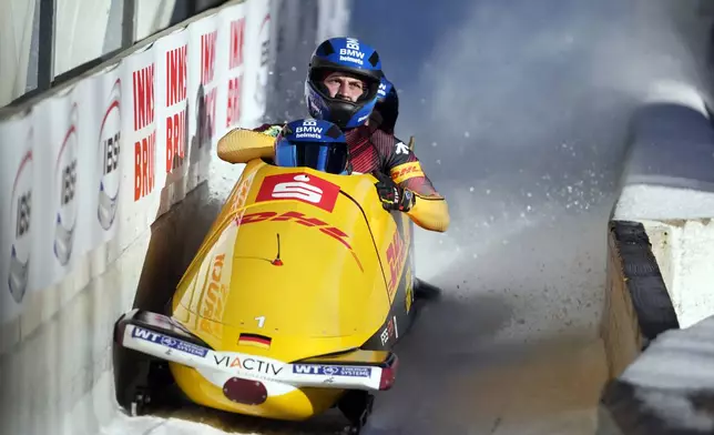 Francesco Friedrich, Matthias Sommer, Alexander Schueller and Felix Straub, of Germany, finish their second run in the 4-man bobsleigh at the Bobsleigh World Cup in Innsbruck, Austria, Sunday, Jan. 19, 2025. (AP Photo/Matthias Schrader)