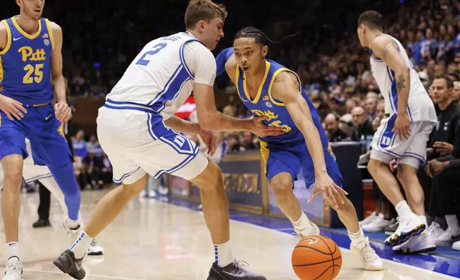 Pittsburgh's Jaland Love is fouled by Duke's Cooper Flagg (2) during the first half of an NCAA college basketball game in Durham, N.C., Tuesday, Jan. 7, 2025. (AP Photo/Ben McKeown)