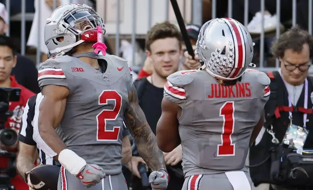 FILE - Ohio State receiver Emeka Egbuka, left, and running back Quinshon Judkins celebrate their touchdown against Iowa during the second half of an NCAA college football game, Saturday, Oct. 5, 2024, in Columbus, Ohio. (AP Photo/Jay LaPrete, File)