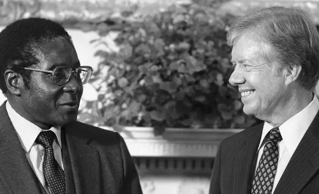 FILE - President Jimmy Carter meets with Zimbabwean Prime Minister Robert Mugabe in the Oval Office of the White House in Washington, Aug. 27, 1980. (AP Photo/Barry Thumma, File)