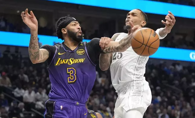 Los Angeles Lakers forward Anthony Davis (3) knocks the ball from Dallas Mavericks forward P.J. Washington (25) during the first half of an NBA basketball game, Tuesday, Jan. 7, 2025, in Dallas. (AP Photo/LM Otero)