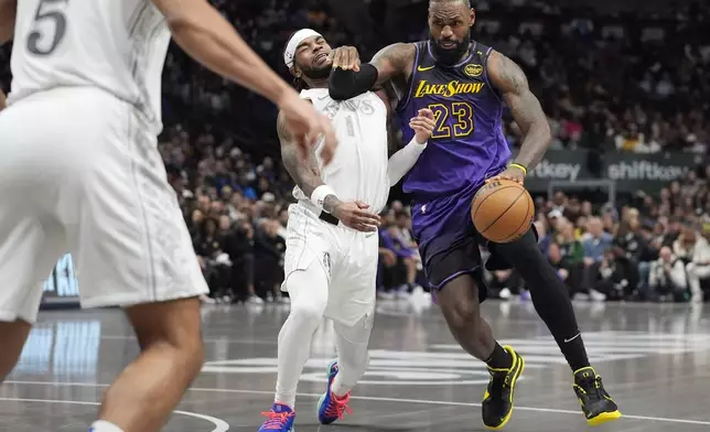 Los Angeles Lakers forward LeBron James (23) tries to get past Dallas Mavericks guard Jaden Hardy (1) during the second half of an NBA basketball game Tuesday, Jan. 7, 2025, in Dallas. (AP Photo/LM Otero)