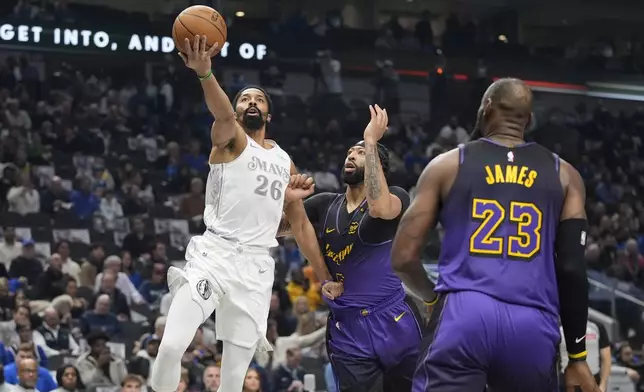 Dallas Mavericks forward P.J. Washington (25) drives against Los Angeles Lakers forwards Anthony Davis (3) and LeBron James (23) during the first half of an NBA basketball game Tuesday, Jan. 7, 2025, in Dallas. (AP Photo/LM Otero)