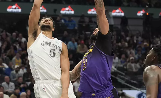 Dallas Mavericks guard Quentin Grimes (5) shoots against Los Angeles Lakers forward Anthony Davis (3) during the first half of an NBA basketball game, Tuesday, Jan. 7, 2025, in Dallas. (AP Photo/LM Otero)