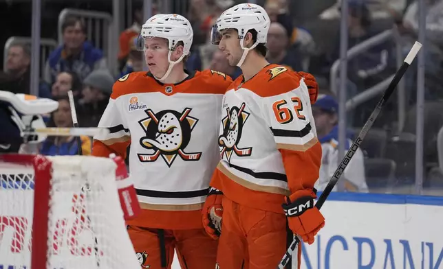 Anaheim Ducks' Nikita Nesterenko (62) is congratulated by teammate Jackson LaCombe after scoring during the first period of an NHL hockey game against the St. Louis Blues Thursday, Jan. 9, 2025, in St. Louis. (AP Photo/Jeff Roberson)