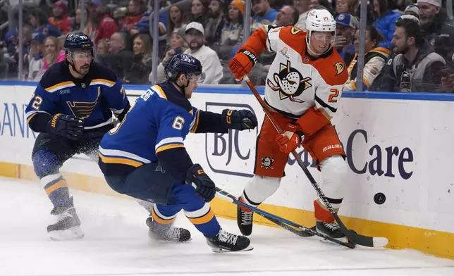 Anaheim Ducks' Isac Lundestrom (21) chases after a loose puck as St. Louis Blues' Philip Broberg (6) and Justin Faulk (72) defend during the third period of an NHL hockey game Thursday, Jan. 9, 2025, in St. Louis. (AP Photo/Jeff Roberson)