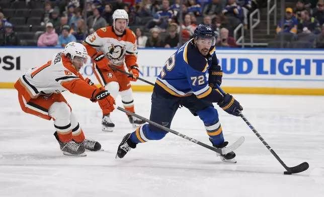 St. Louis Blues' Justin Faulk (72) handles the puck as Anaheim Ducks' Cutter Gauthier defends during the third period of an NHL hockey game Thursday, Jan. 9, 2025, in St. Louis. (AP Photo/Jeff Roberson)