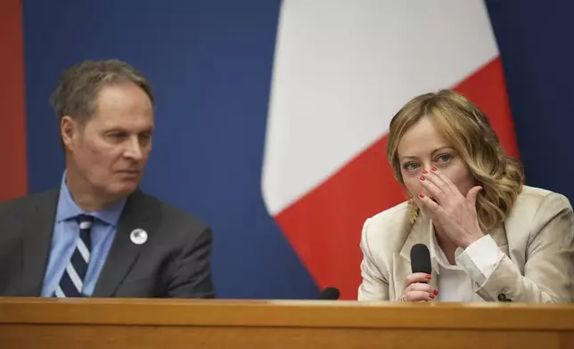 Italian Premier Giorgia Meloni holds the 2024 year-end press conference, flanked by the Italian president of the Order of Journalists, Carlo Bartoli, in Rome, Thursday, Jan. 9, 2025. (AP Photo/Alessandra Tarantino)